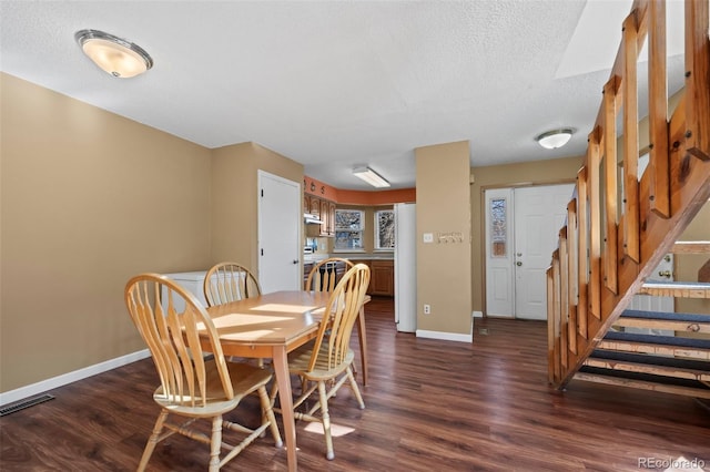 dining room with dark wood-type flooring, visible vents, stairway, and baseboards