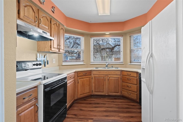 kitchen with under cabinet range hood, white refrigerator with ice dispenser, a sink, light countertops, and electric range oven