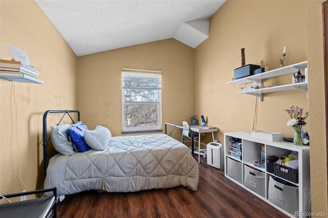 bedroom featuring a textured ceiling, vaulted ceiling, and wood finished floors