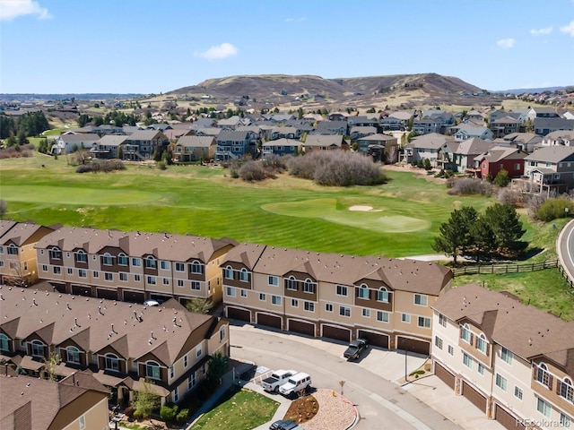 aerial view featuring a residential view, a mountain view, and golf course view