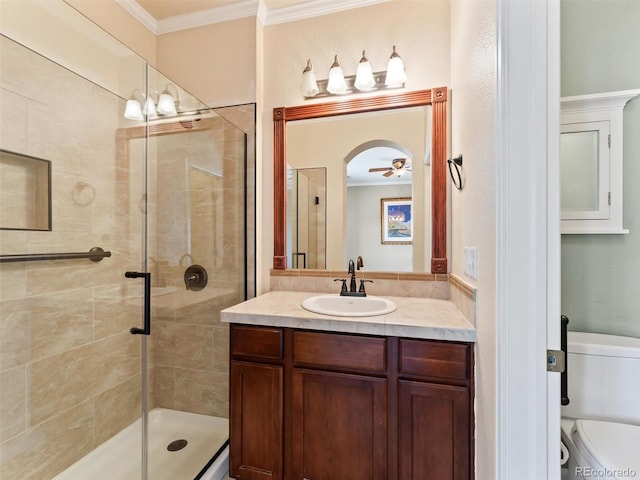 full bath featuring crown molding, vanity, a shower stall, and toilet
