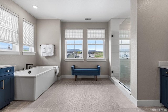 bathroom featuring separate shower and tub and vanity