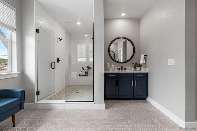 bathroom with walk in shower and vanity