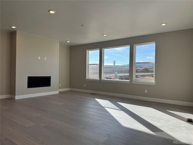 unfurnished living room with wood-type flooring