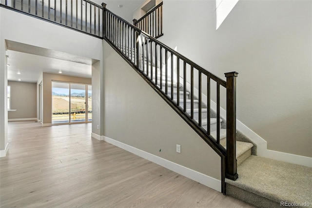 stairway featuring wood finished floors and baseboards