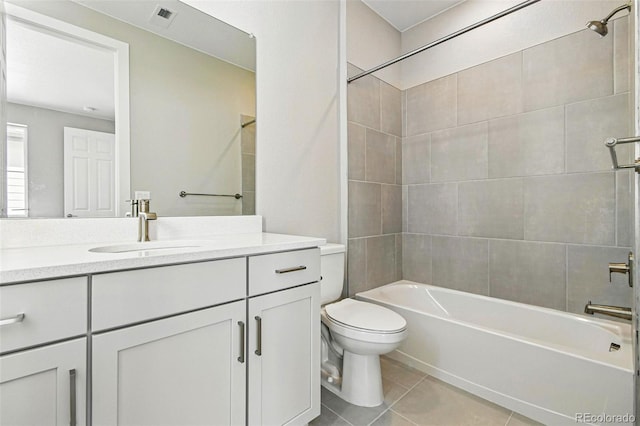 full bath with tile patterned floors, toilet, bathtub / shower combination, visible vents, and vanity