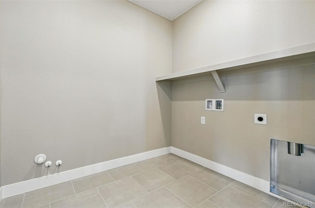 laundry area with laundry area, light tile patterned flooring, gas dryer hookup, baseboards, and washer hookup