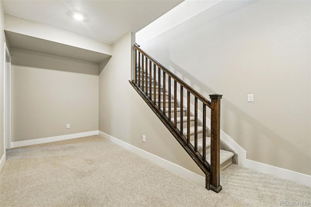 staircase with baseboards and carpet