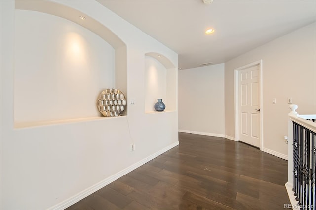 hallway with recessed lighting, baseboards, wood finished floors, and visible vents