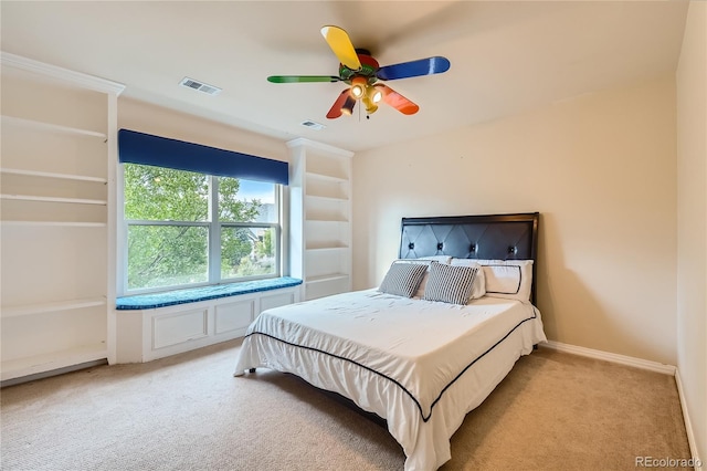 bedroom with baseboards, visible vents, ceiling fan, and light colored carpet
