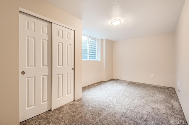 unfurnished bedroom featuring carpet flooring and a closet