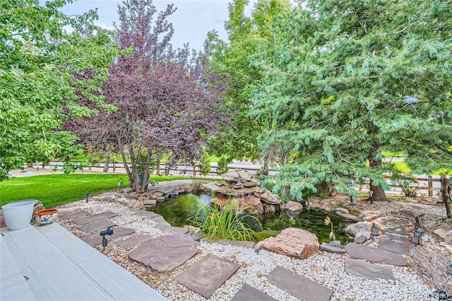 view of yard featuring a garden pond