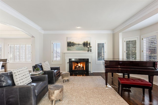 living area featuring hardwood / wood-style flooring and crown molding