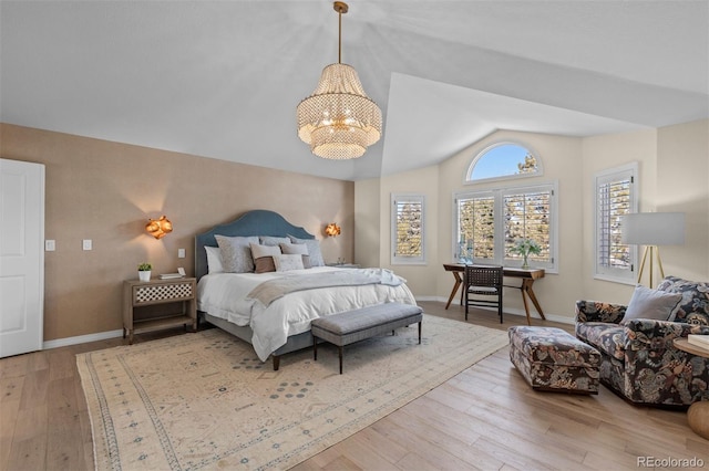 bedroom with vaulted ceiling, a notable chandelier, and light hardwood / wood-style floors