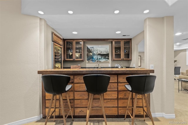 bar featuring sink and carpet flooring