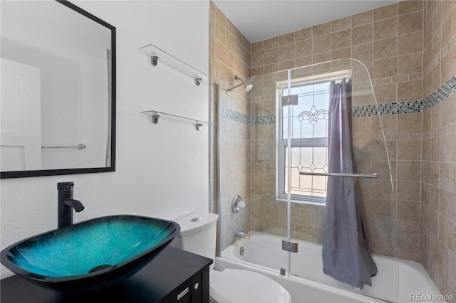 bathroom with vanity, toilet, a healthy amount of sunlight, and shower / tub combo with curtain