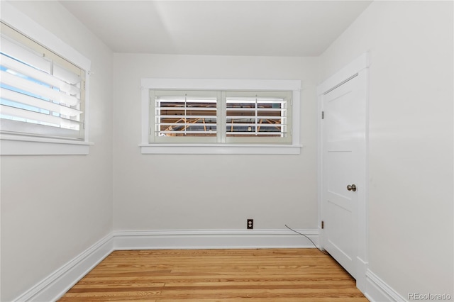 empty room featuring light wood-type flooring and baseboards