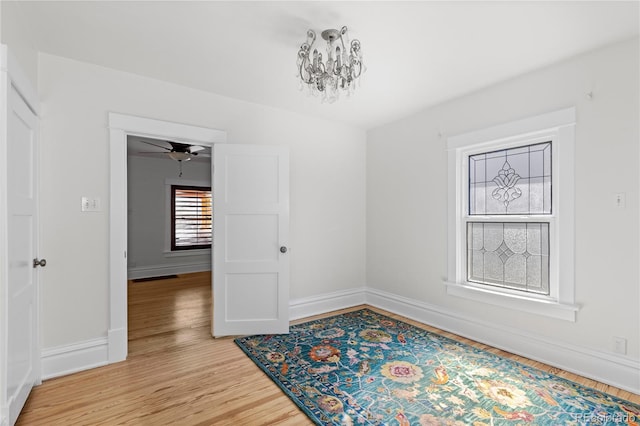 unfurnished dining area featuring light wood-style flooring, baseboards, and ceiling fan