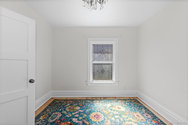 unfurnished room featuring wood finished floors and baseboards