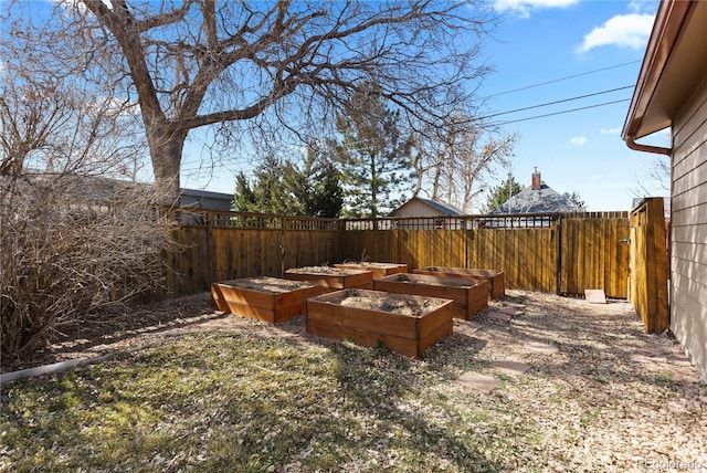 view of yard with fence private yard and a vegetable garden