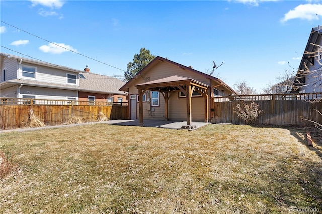 back of house featuring a gazebo, a lawn, a fenced backyard, and a patio area