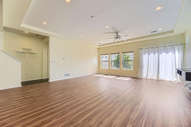 5495 Espana Ct, Denver, CO 80249 - unfurnished living room featuring ceiling fan, a raised ceiling, wood finished floors, and recessed lighting