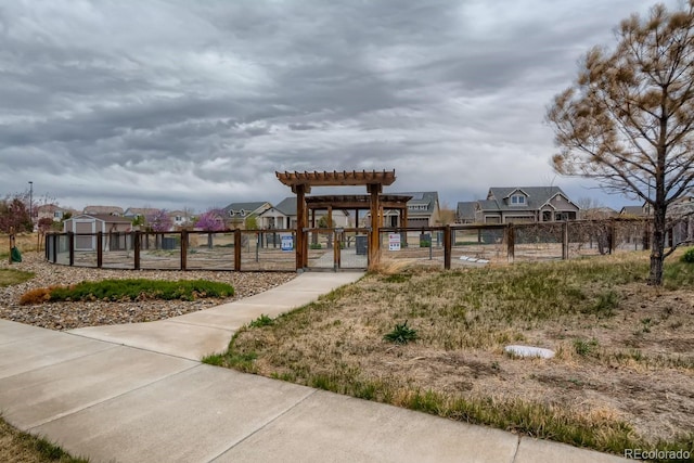 5495 Espana Ct, Denver, CO 80249 - view of property's community featuring a gate, a pergola, and a residential view
