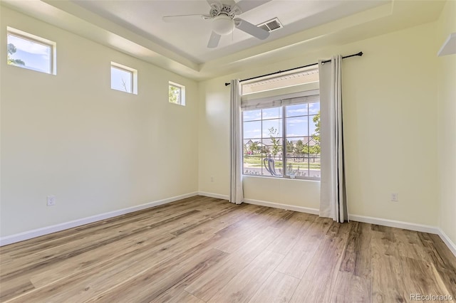 5495 Espana Ct, Denver, CO 80249 - spare room featuring light wood-style flooring, a raised ceiling, and ceiling fan