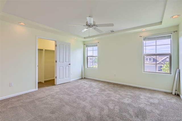 5495 Espana Ct, Denver, CO 80249 - unfurnished bedroom featuring carpet, recessed lighting, a walk in closet, a ceiling fan, and a closet