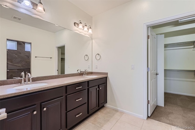 5495 Espana Ct, Denver, CO 80249 - full bath with double vanity, tile patterned flooring, and a spacious closet