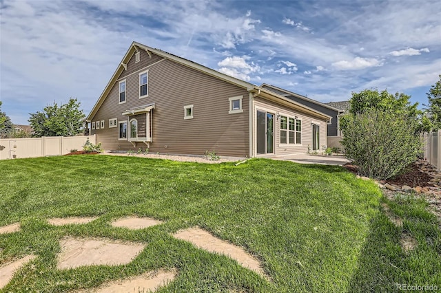 5495 Espana Ct, Denver, CO 80249 - back of property with a fenced backyard and a patio