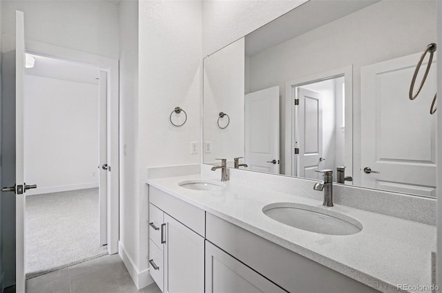9382 Quaker St, Arvada, CO 80007 - bathroom featuring double vanity, tile patterned floors, and baseboards