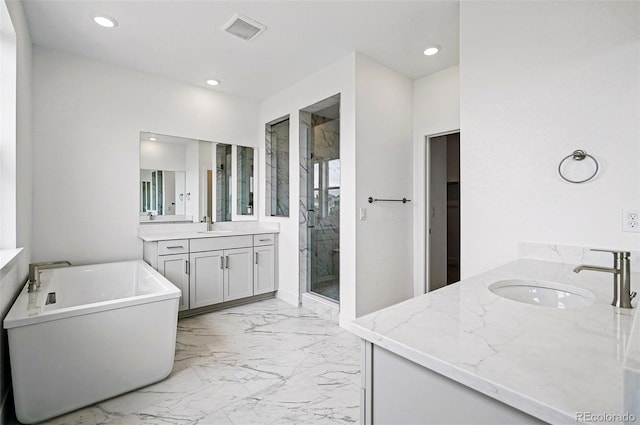 9382 Quaker St, Arvada, CO 80007 - full bath featuring two vanities, a stall shower, marble finish floors, recessed lighting, and a soaking tub