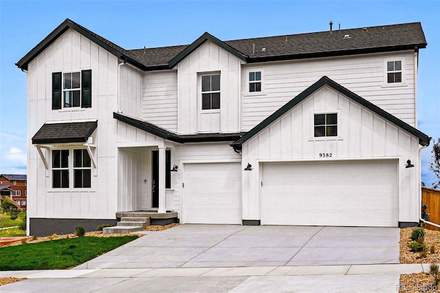 9382 Quaker St, Arvada, CO 80007 - modern inspired farmhouse with board and batten siding, a garage, concrete driveway, and a shingled roof
