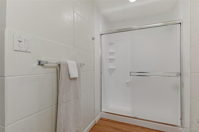 9650 Huron St Unit 12, Thornton, CO 80260 - bathroom with a shower stall and wood finished floors