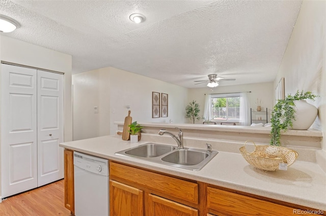 9650 Huron St Unit 12, Thornton, CO 80260 - kitchen with dishwasher, a textured ceiling, light wood-style flooring, light countertops, and a ceiling fan