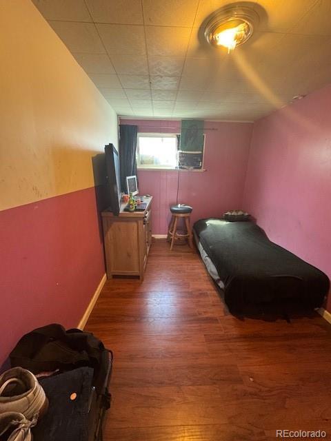 bedroom with wood finished floors and baseboards