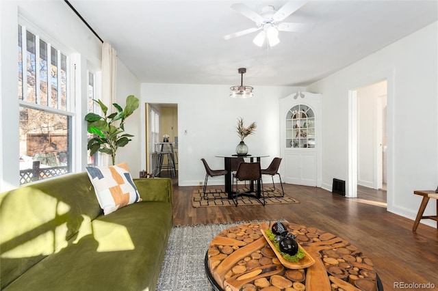 living room with ceiling fan and dark hardwood / wood-style flooring