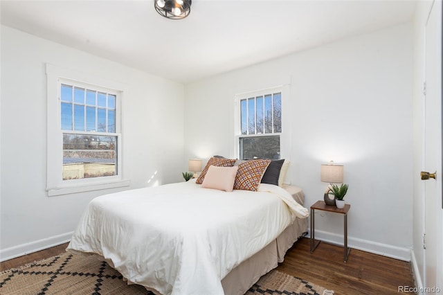 bedroom with dark wood-type flooring