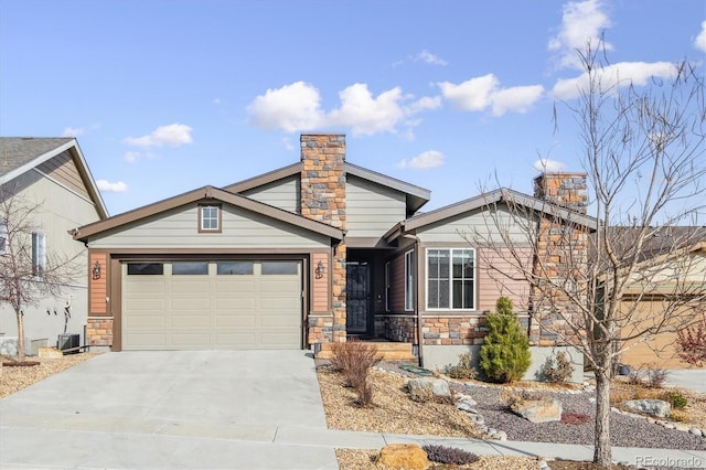 view of front of home featuring cooling unit and a garage