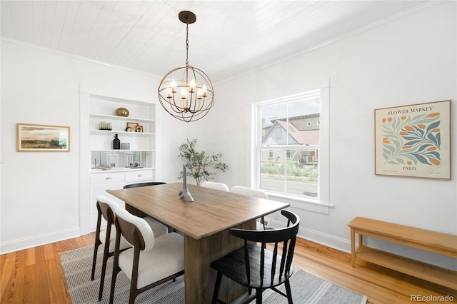 4363 N Raleigh St, Denver, CO 80212 - dining space with light wood-type flooring, a chandelier, crown molding, and built in shelves