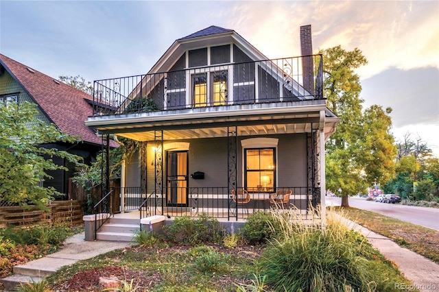 4363 N Raleigh St, Denver, CO 80212 - view of front of house with covered porch, a chimney, and a balcony