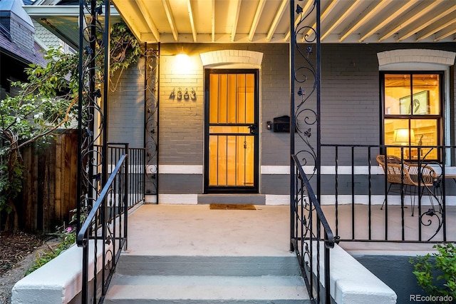 4363 N Raleigh St, Denver, CO 80212 - view of exterior entry featuring brick siding and a porch
