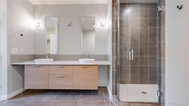 bathroom featuring vanity, tile patterned floors, and a shower with door