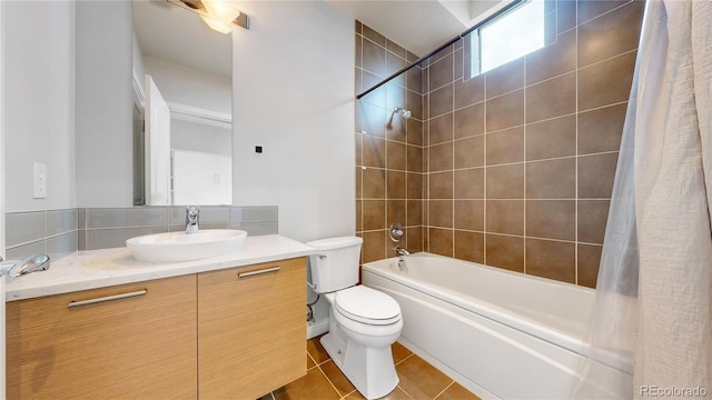 full bathroom with shower / bath combo with shower curtain, tile patterned flooring, vanity, and toilet