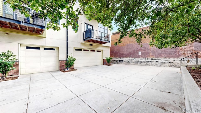 exterior space with a balcony and a garage