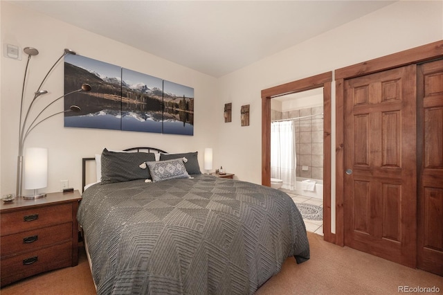 carpeted bedroom featuring ensuite bathroom