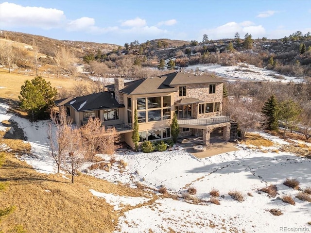 view of front of property featuring a deck with mountain view