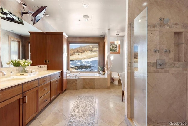 full bathroom featuring tile patterned flooring, vanity, separate shower and tub, and toilet