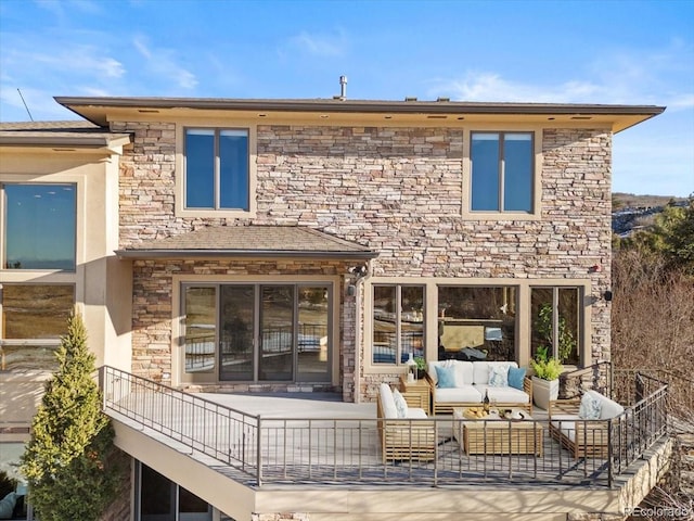 rear view of property with an outdoor living space